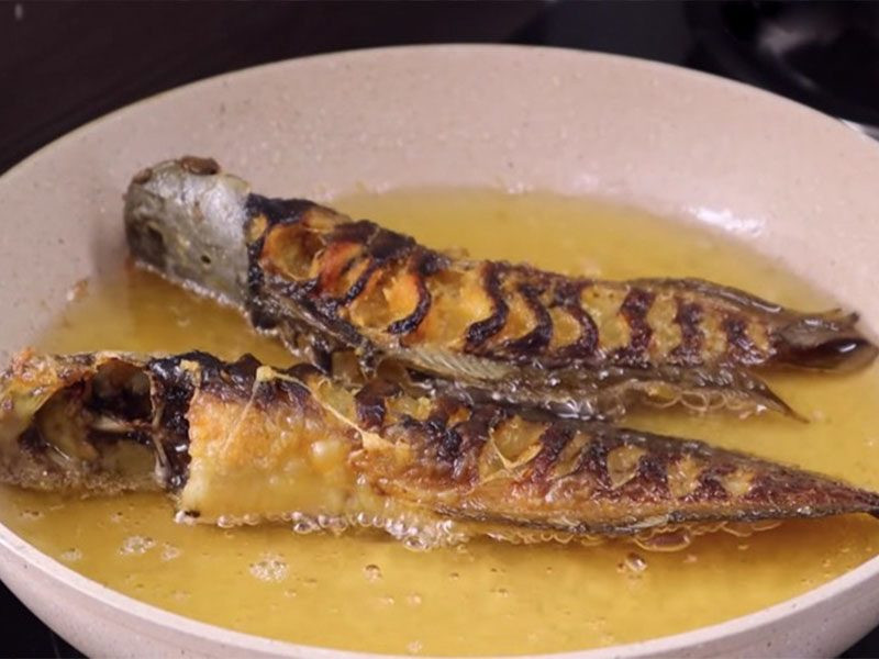 Frying the catfish until golden brown