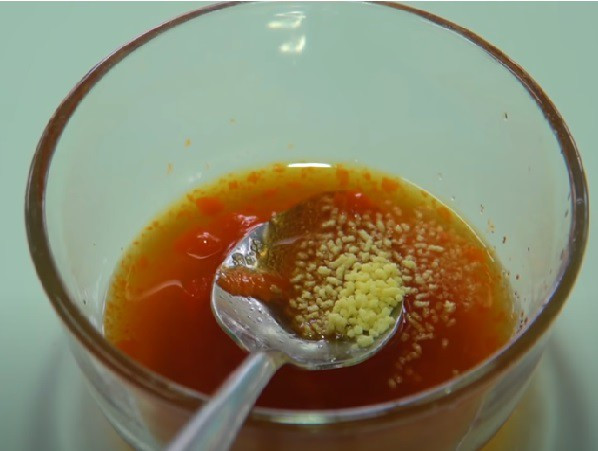 Mixing fish sauce, sugar, and chili sauce in a small bowl