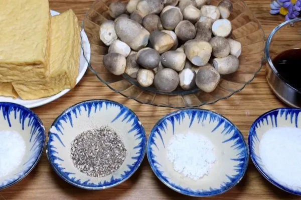 Preparing straw mushrooms and cutting tofu into bite-sized pieces