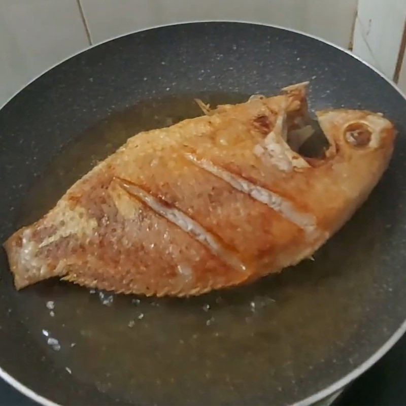 Frying the fish until golden on both sides