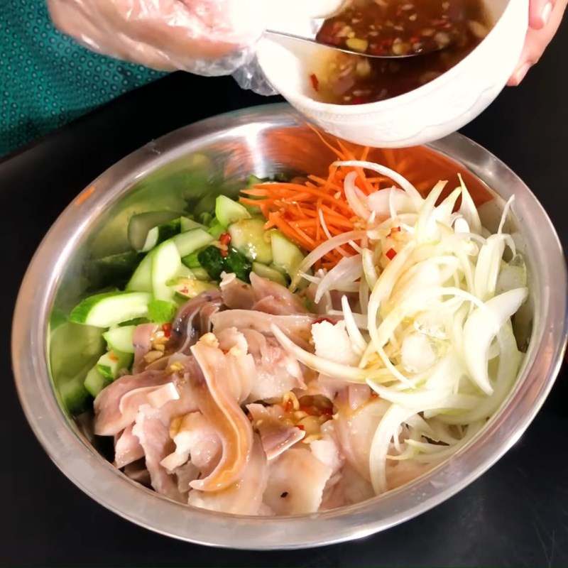 Tossing pork ear and cucumber salad