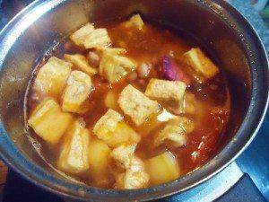 Sautéing tomatoes and cooking potatoes
