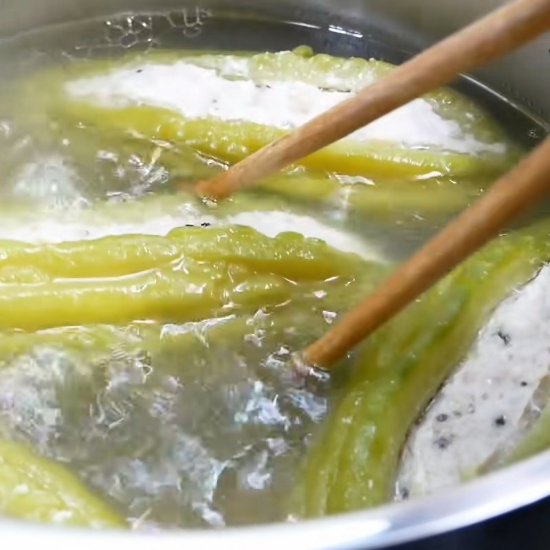 Step 5: Adding green onions and cilantro to the simmering soup