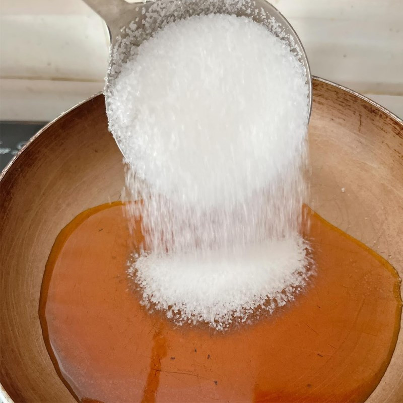 A bowl of Vietnamese salad dressing made with fish sauce, sugar, lime juice, minced garlic, and chili.