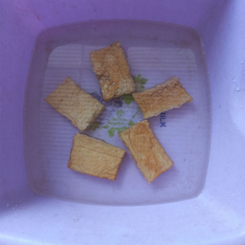 Prepping lemongrass, chili, garlic, and fried tofu for braising