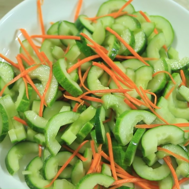 Tossing the cucumber and carrot salad
