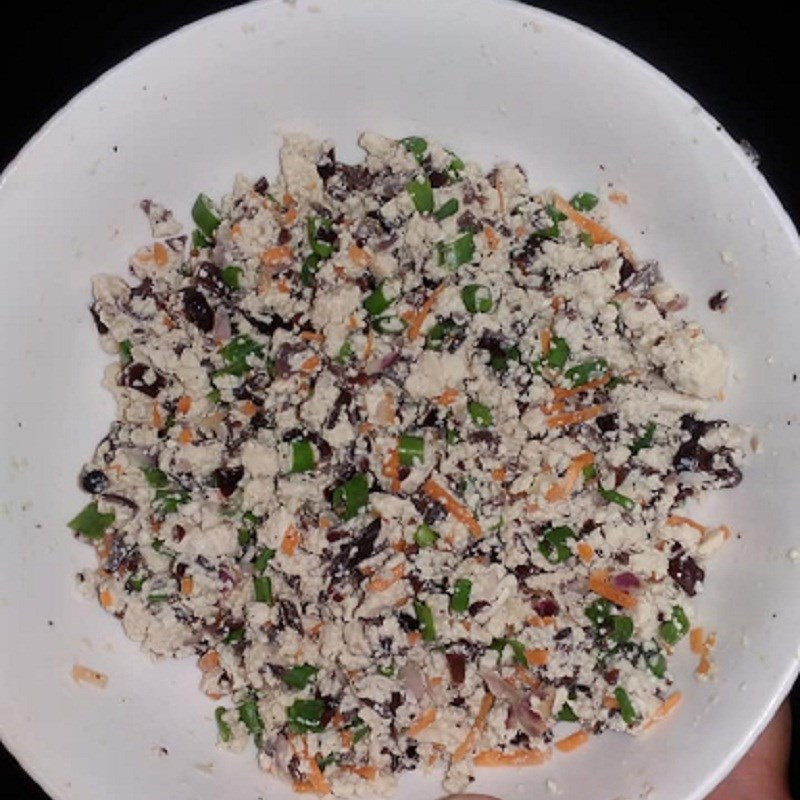 Step 3: Mixing tofu with chopped vegetables and seasonings for the filling